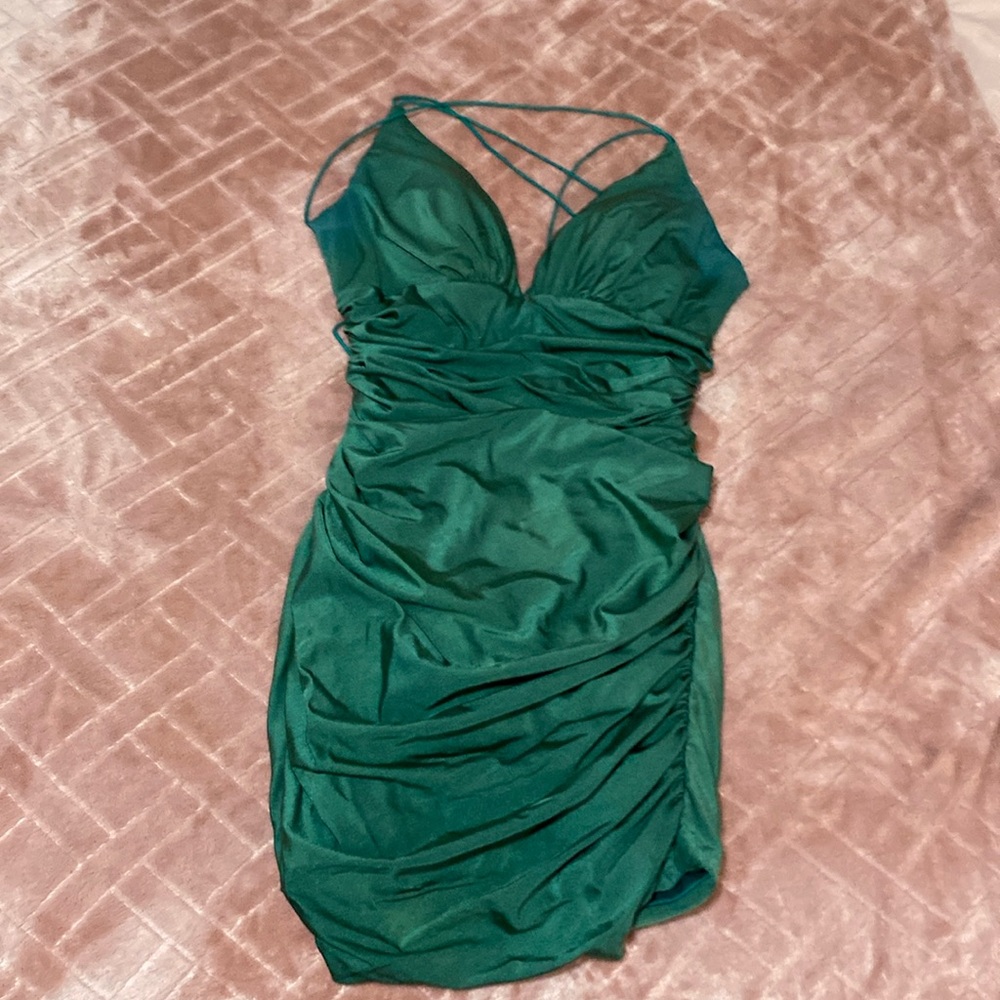 Figure-flattering dark emerald green satin homecoming dress.